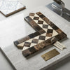 Geometric mosaic Emperador dark marble tile with interlocking cream-colored triangles forming diamond design