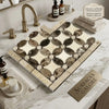 A polished emperador dark marble mosaic sink with cream and dark brown veined tiles in a geometric pattern