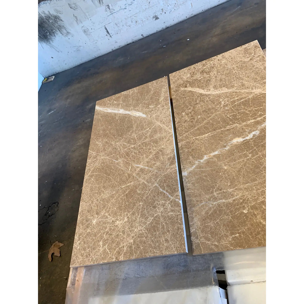 Emperador Light Marble 4X4 Tumbled with two brown marble tiles featuring white veining