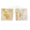 Two square textured soap bars on Giallo Reale Marble Tumbled Tile background