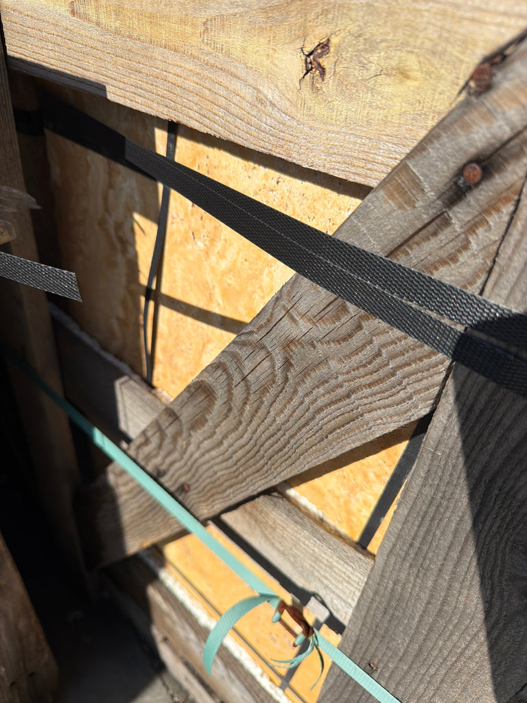 Black woven strap securing Gold/Yellow Travertine Versailles pattern planks