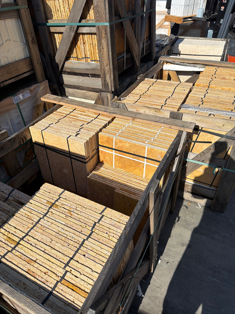 Gold yellow travertine Versailles pattern tumbled tile set in crates