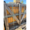 Weathered wooden crate with gold-yellow travertine Versailles pattern set, secured by teal straps