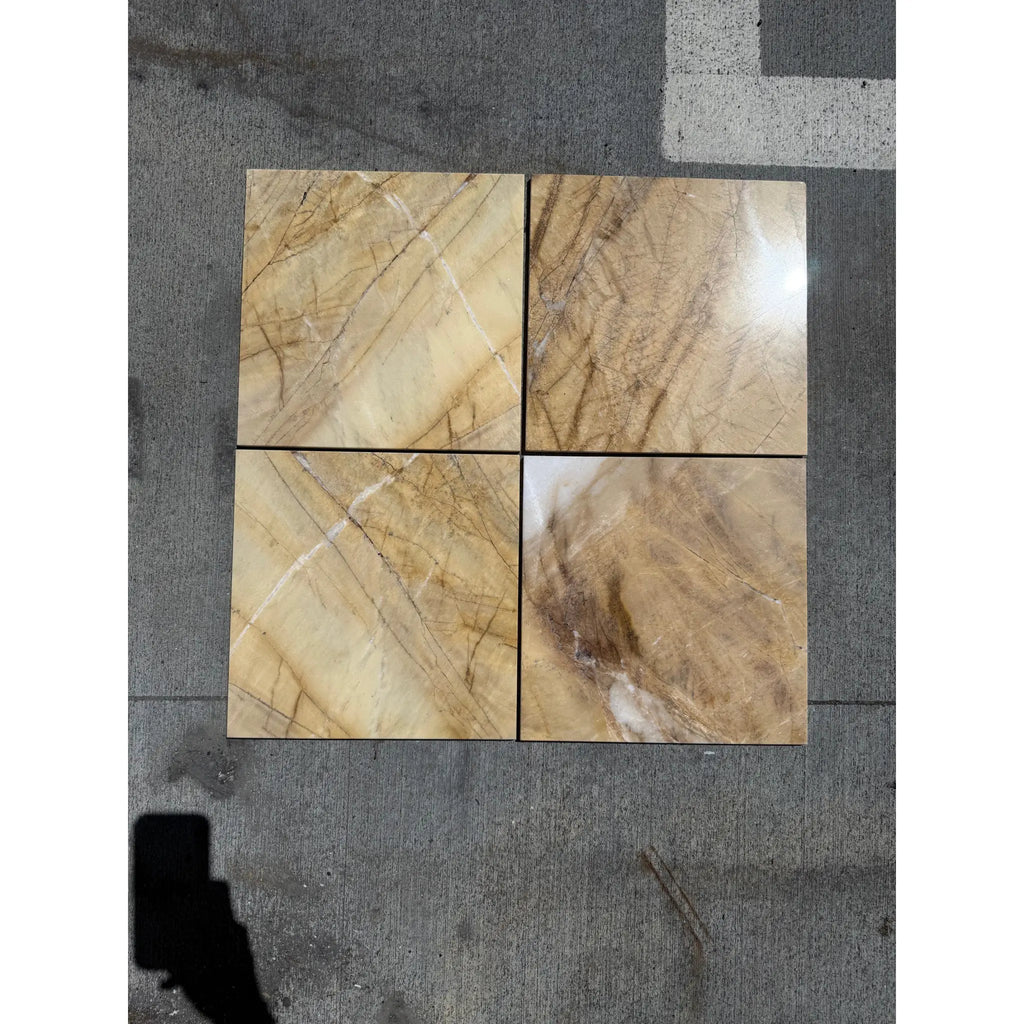Four polished Golden Horizon Marble 12x12 tiles with brown and beige veining
