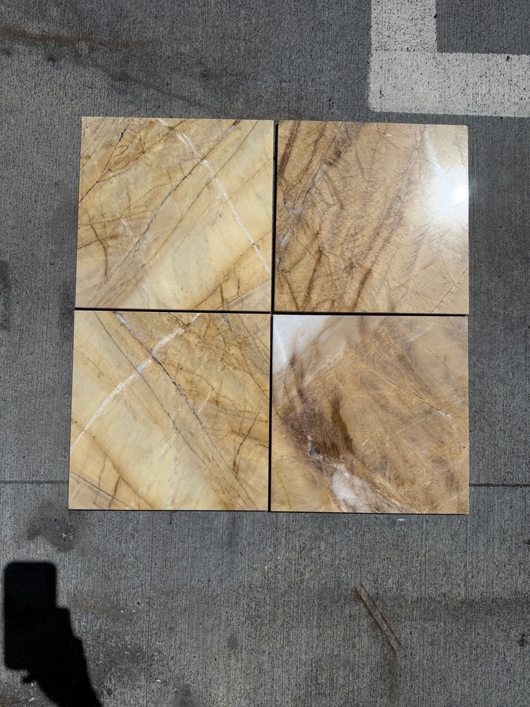 Four polished Golden Horizon Marble 12x12 tiles with brown and beige veining