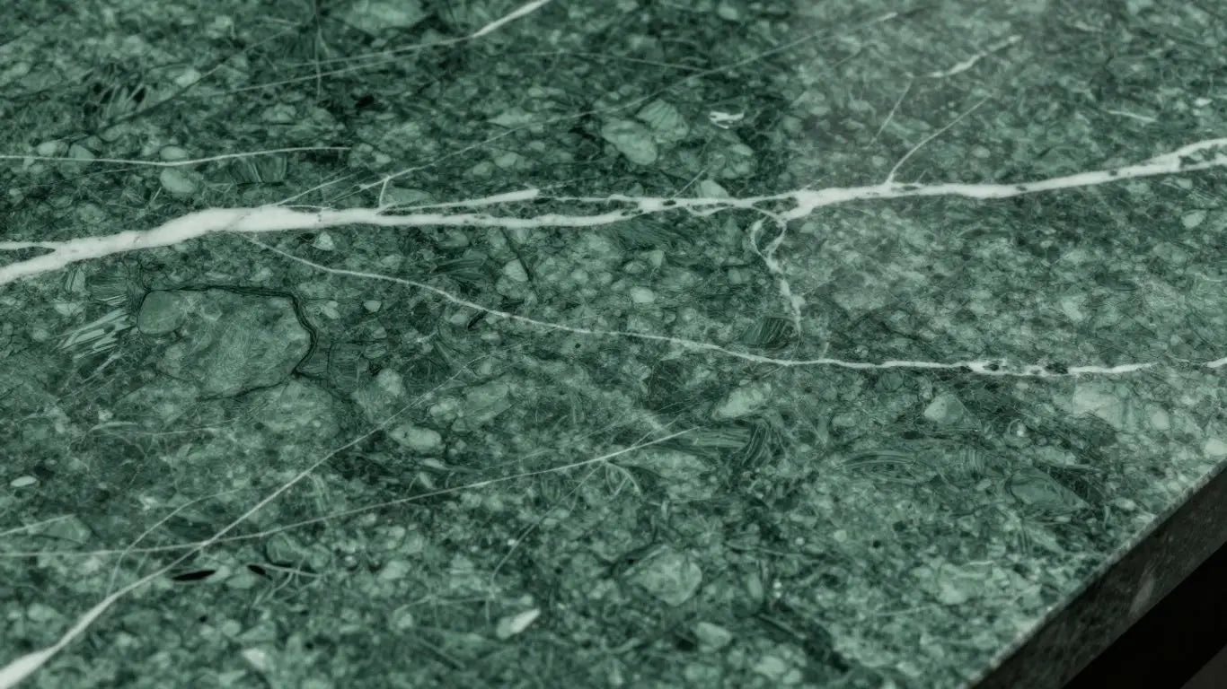 Verde Alpi marble with green hues and white veining.