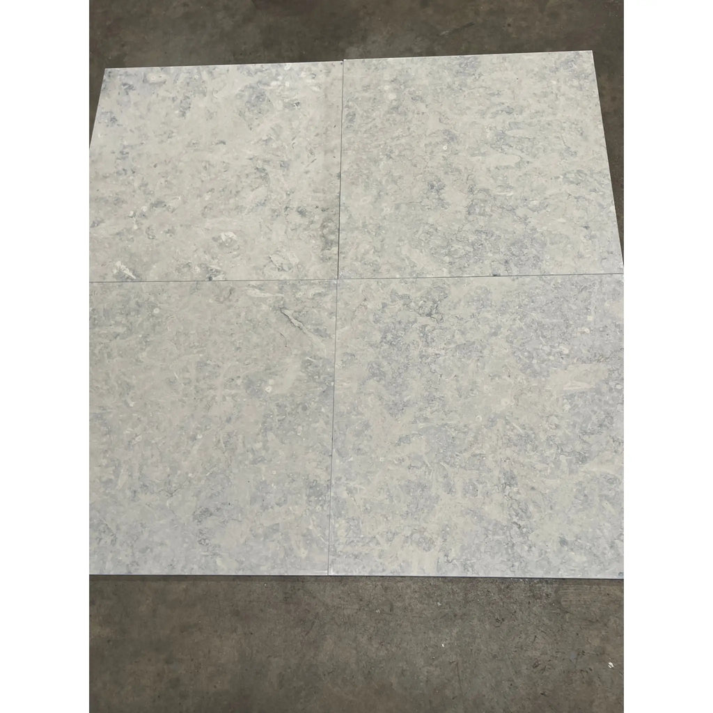 Four Greyhaven 12x12 honed limestone tiles in gray marble grid