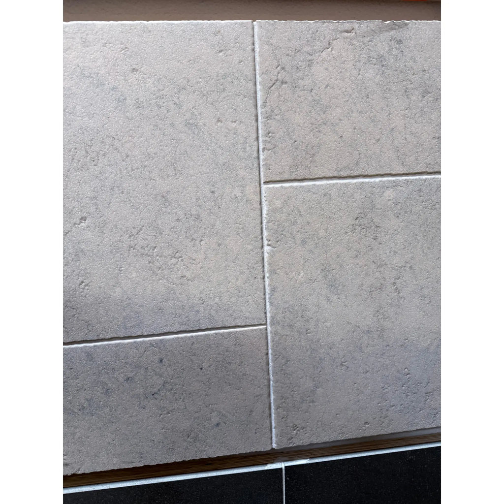 Greyhaven 12x12 limestone honed gray stone-effect wall tiles with subtle texture and grout lines