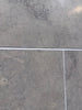 Greyhaven 12x12 honed limestone tile with gray stone, subtle veining, white grout