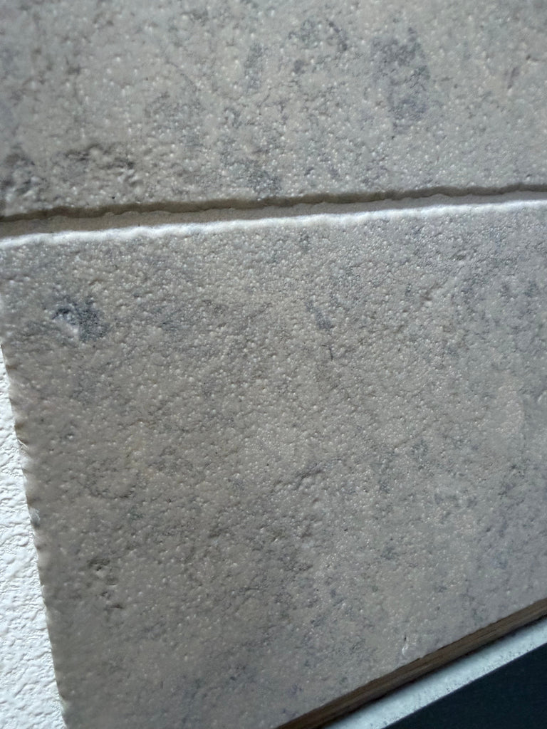 Greyhaven 12x12 honed limestone tile with gray textured surface and subtle speckles
