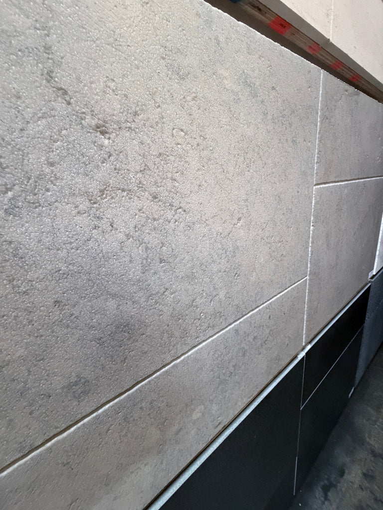 Greyhaven 12x12 honed limestone tile with gray textured veining and matte finish