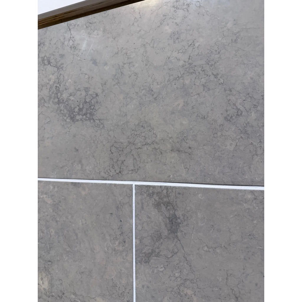 Greyhaven 12x24 honed limestone tiles in gray marble effect with veining