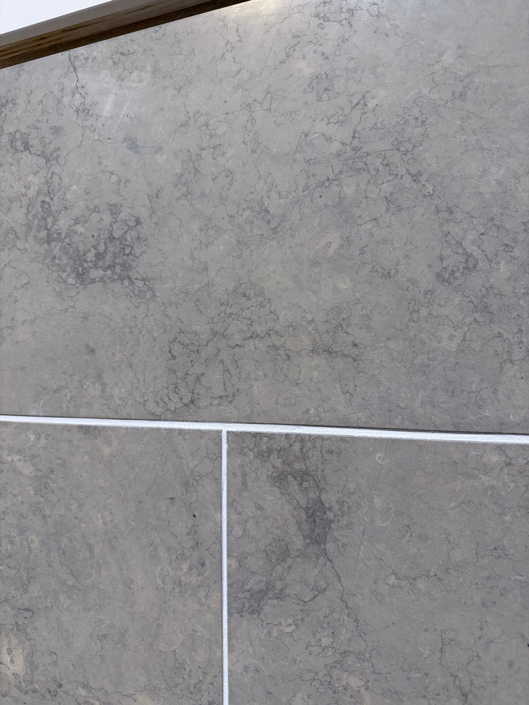 Greyhaven 12x24 honed limestone tiles in gray marble effect with veining