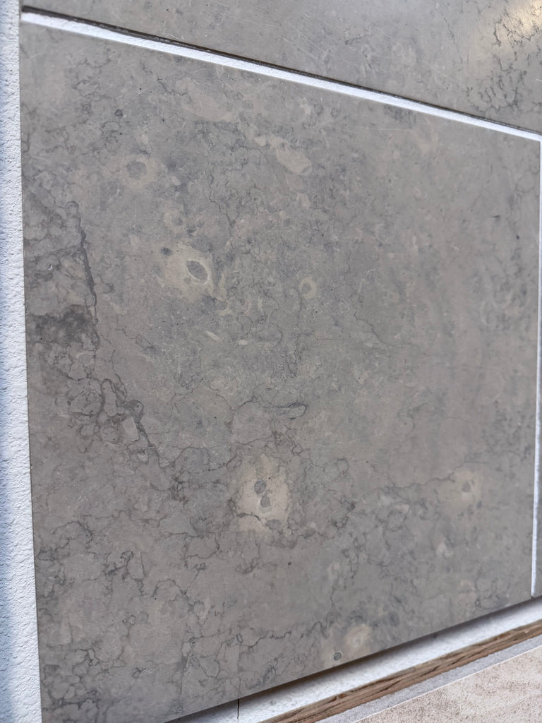 Greyhaven 12x24 honed limestone tile with gray stone, natural veining