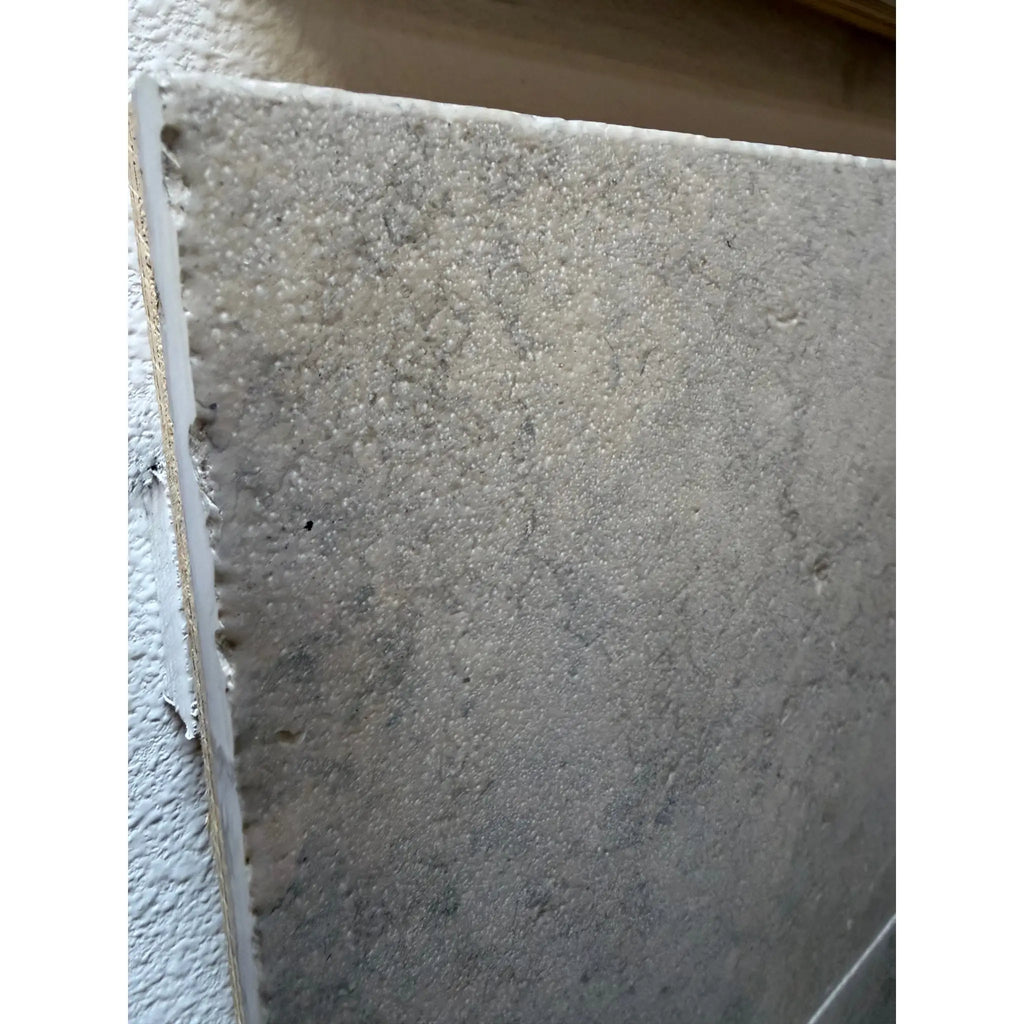 Gray textured Greyhaven 12x24 limestone honed slab with rough speckled surface