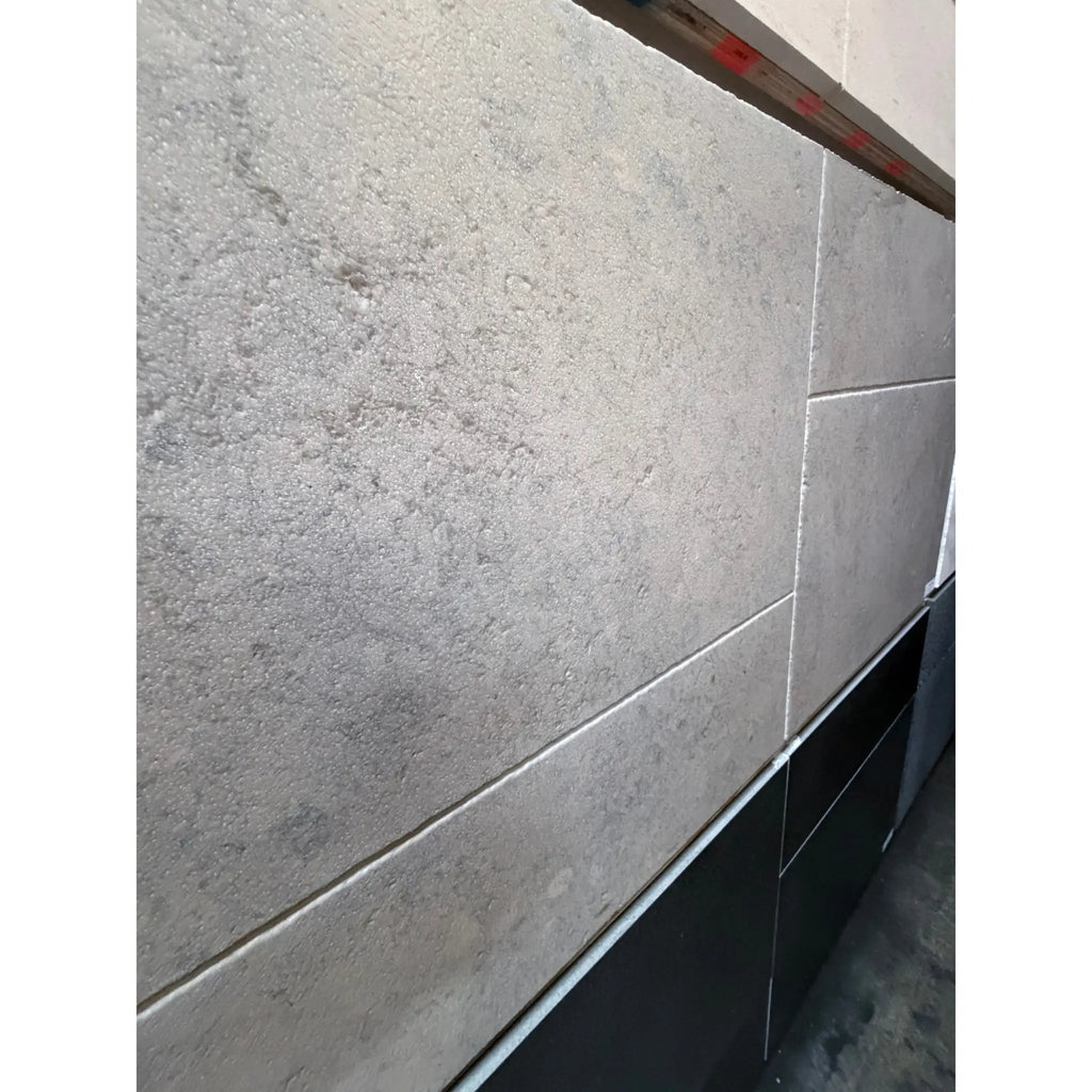 Greyhaven 12x24 limestone honed tiles in gray textured stone with subtle veining and matte finish