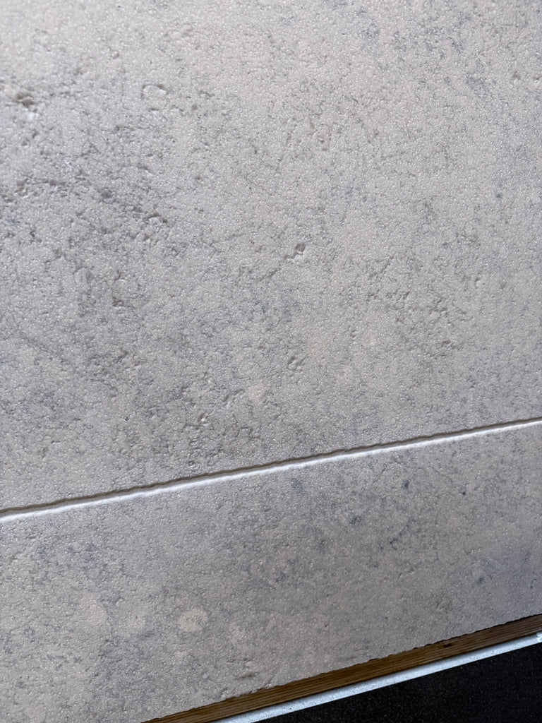 Greyhaven 12x24 limestone honed tile with gray textured matte finish and subtle speckles