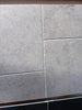 Gray stone-effect Greyhaven 18x18 limestone honed wall tiles with subtle texture and grout lines