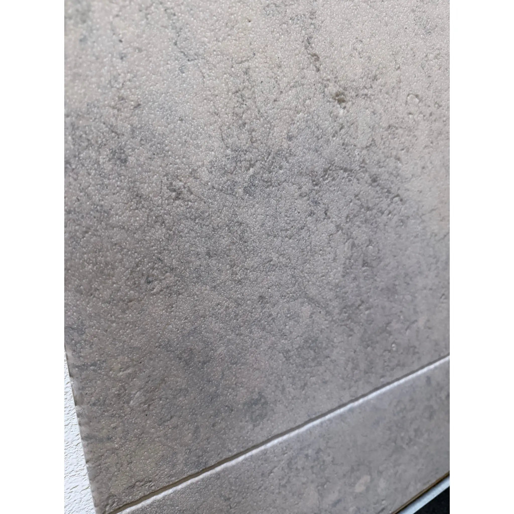 Gray textured Greyhaven 18x18 limestone honed tile with subtle speckled matte finish