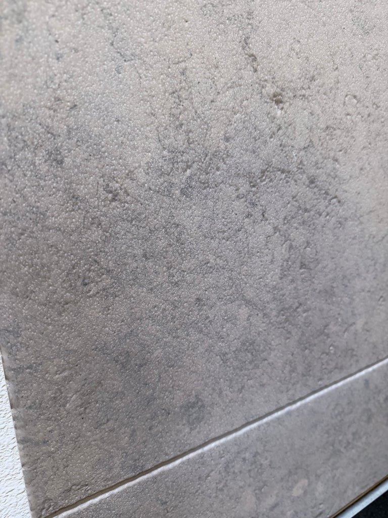 Gray textured Greyhaven 18x18 limestone honed tile with subtle speckled matte finish