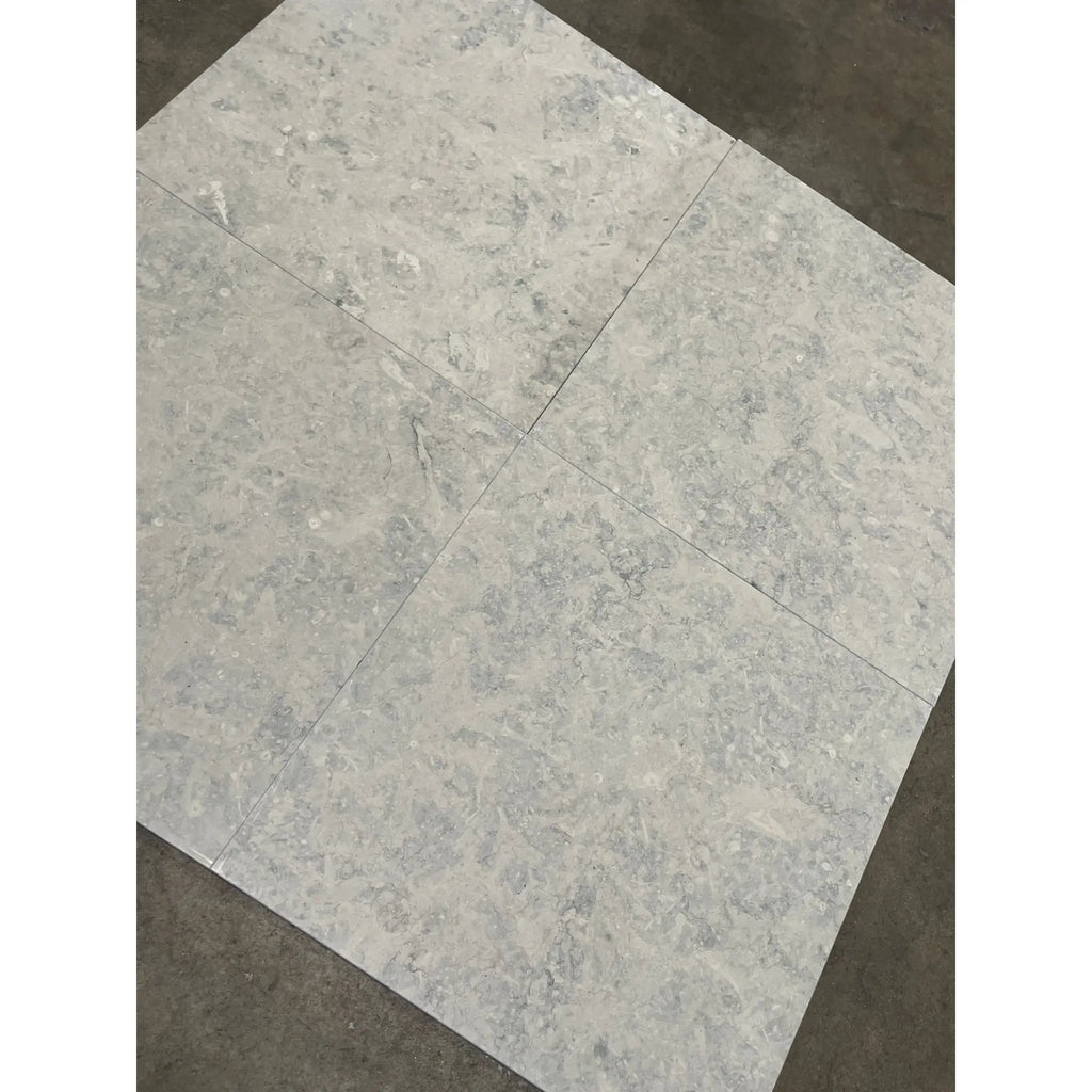 Greyhaven 24x24 honed limestone tiles with gray marble-effect veining and polished surface