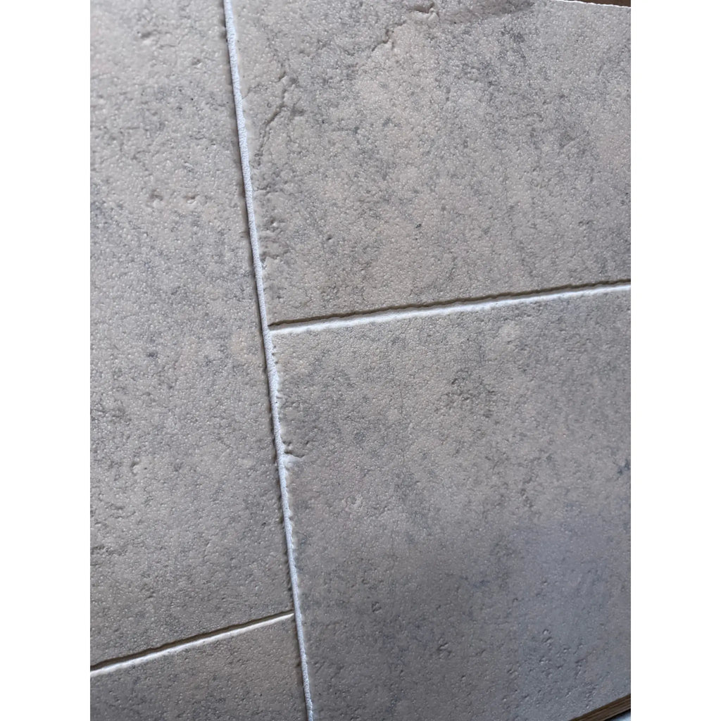 Greyhaven 24x24 honed limestone tiles with gray stone-effect, textured matte finish and subtle veining