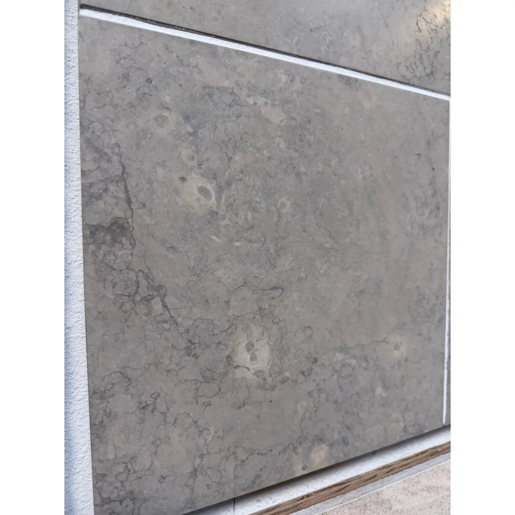 Greyhaven 24x24 honed limestone tile with gray stone veining and subtle light patches
