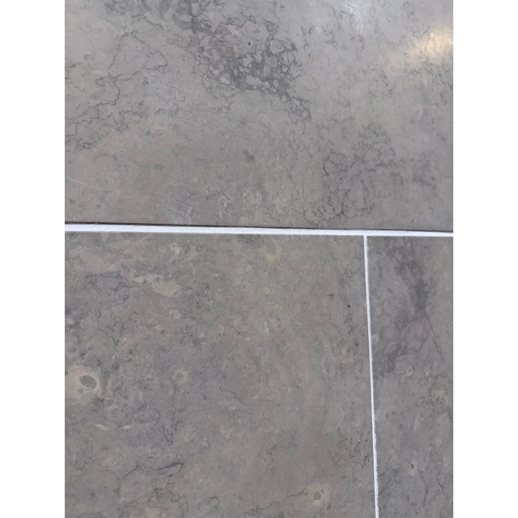 Greyhaven 24x24 honed limestone tiles with gray stone, subtle veining, white grout