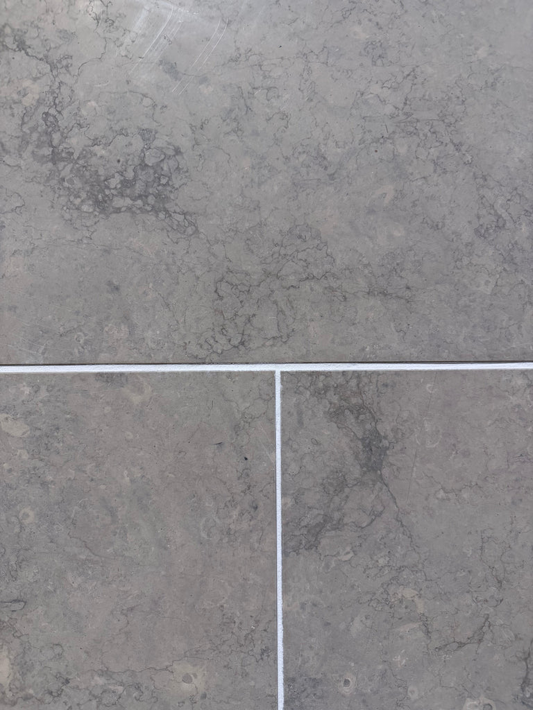 Greyhaven 24x24 honed limestone tiles with gray stone, subtle veining, matte finish, thin white grout