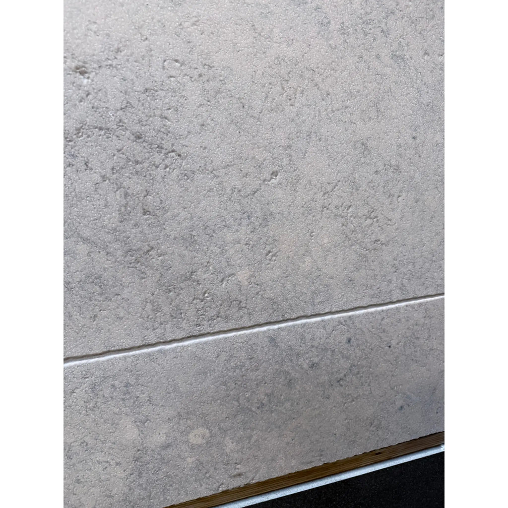 Greyhaven 24x24 honed limestone tile with gray textured wall finish