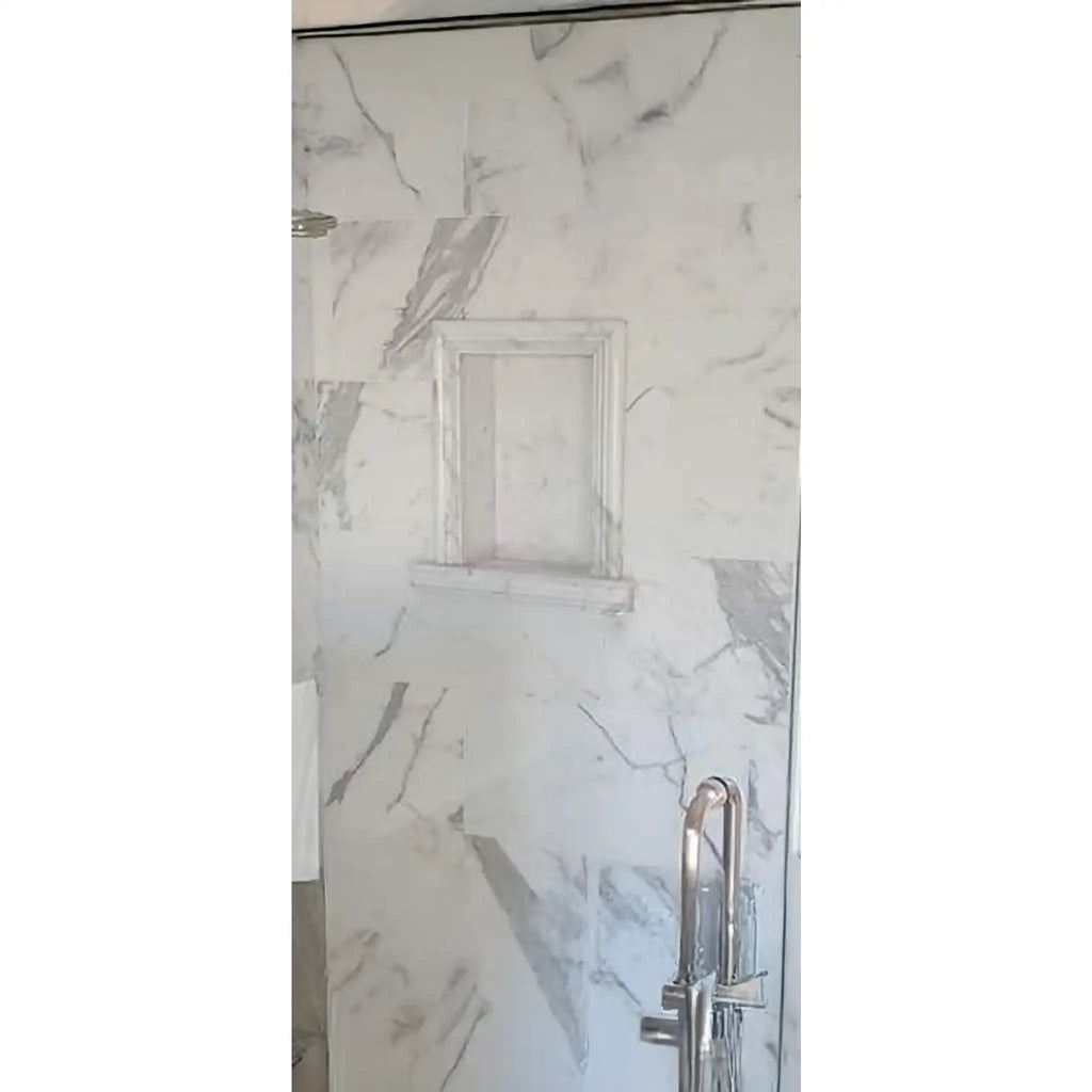 Hand Made Marble Shampoo Niche in a marble-tiled shower with recessed shelf