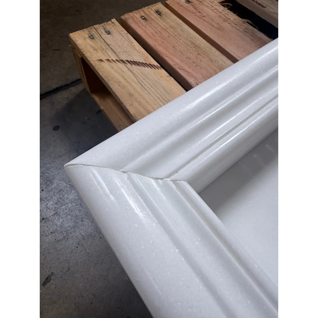 Close-up of a white glossy ribbed PVC mitered corner in a Hand Made Marble Shampoo Niche