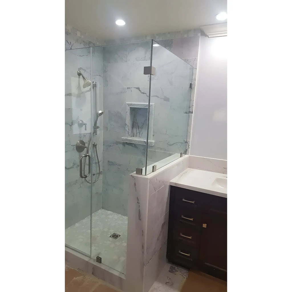 Modern glass shower enclosure featuring Hand Made Marble Shampoo Niche for elegant bathrooms