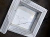 Handmade white marble shampoo niche with veined surface and recessed molding