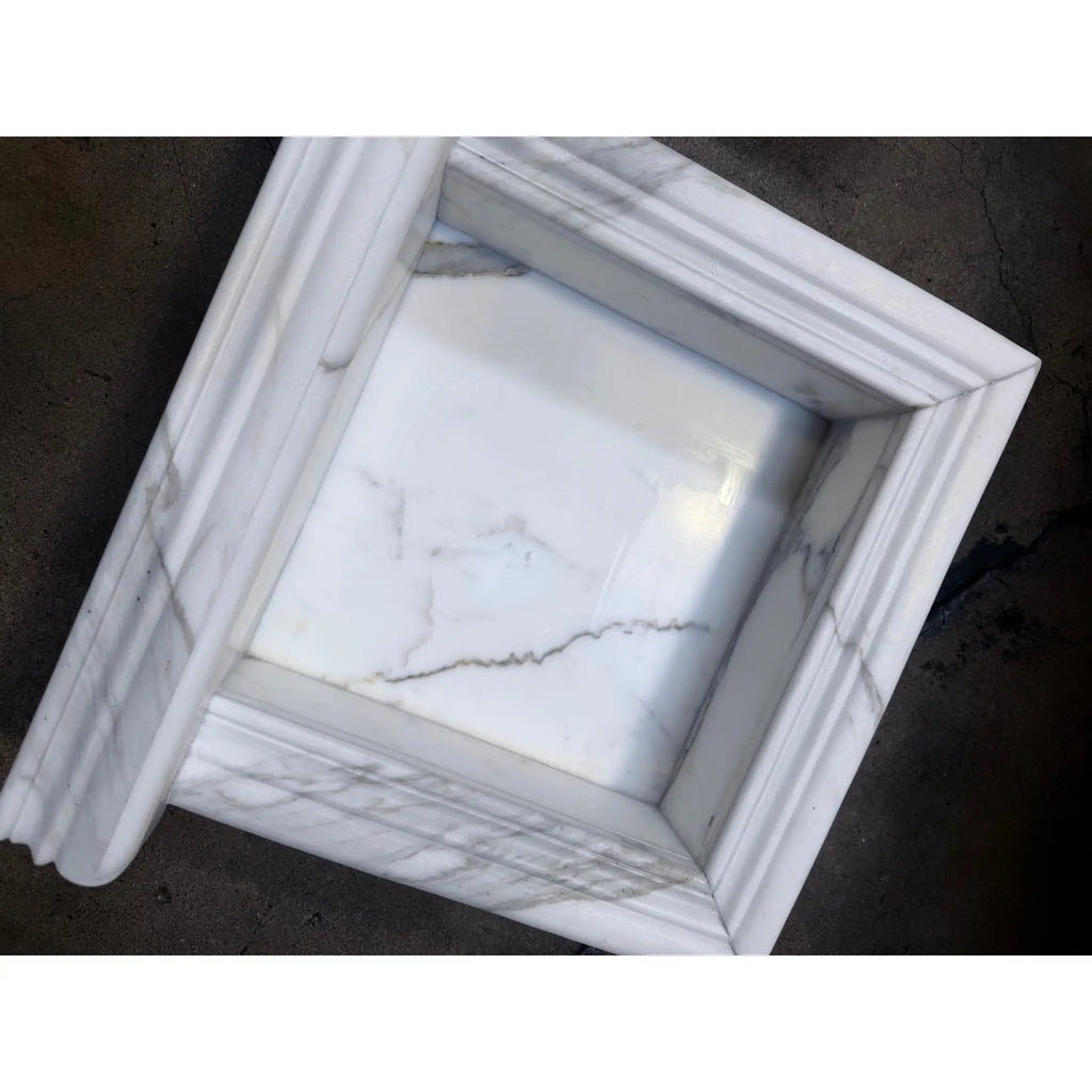 Handmade white marble shampoo niche with veined surface and recessed molding