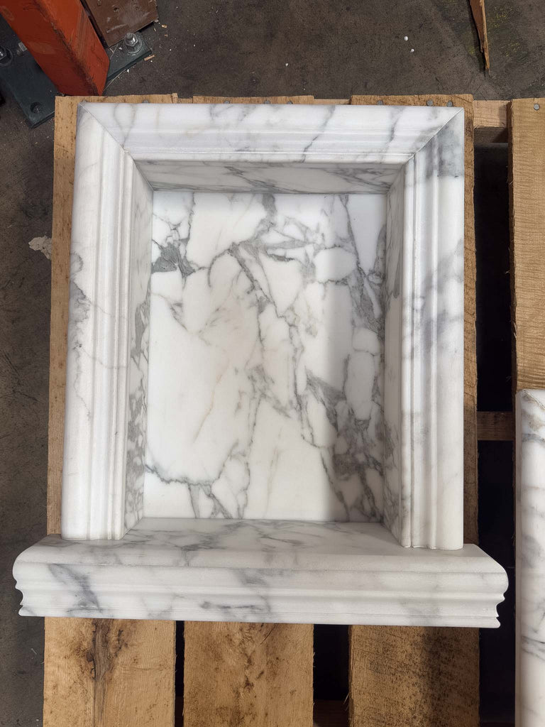 White marble fireplace surround with rectangular inset and fluted design for Hand Made Marble Shampoo Niche