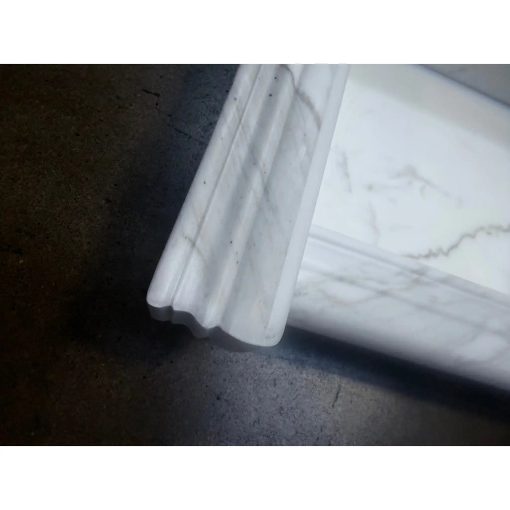 Handmade white marble shampoo niche with ornate fireplace mantel profile