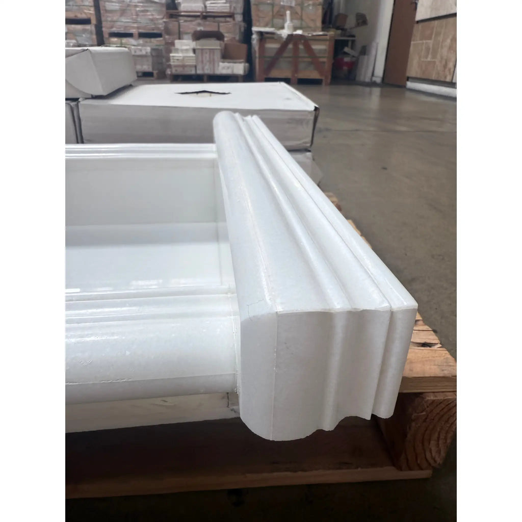 White fluted architectural trim on a wooden pallet for Hand Made Marble Shampoo Niche