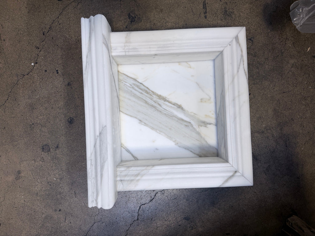 Handmade white marble shampoo niche with carved frame and veined inset