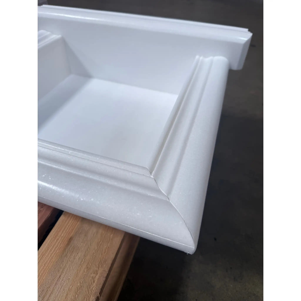 White glossy framed kitchen cabinet door or drawer front in a Handmade Marble Shampoo Niche