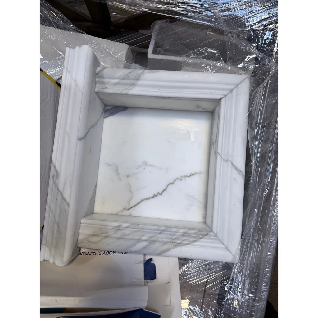 Elegant white marble shampoo niche with classic frame and gray veining