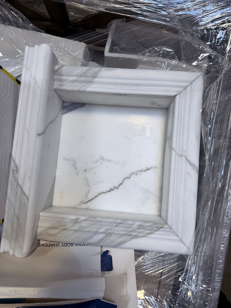Elegant white marble shampoo niche with classic frame and gray veining