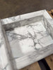 White marble sink with grey veining in handcrafted Marble Shampoo Niche