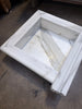 Handmade marble shampoo niche with white square basin, fluted edges, gray veining