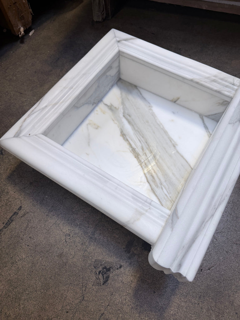 Handmade marble shampoo niche with white square basin, fluted edges, gray veining