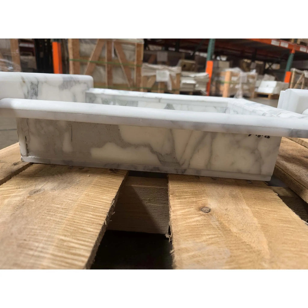 White marble trough sink with gray veining in the Hand Made Marble Shampoo Niche