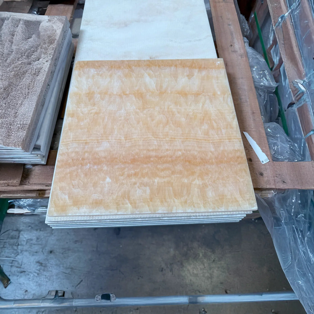 Stacked orange marble tiles of Honey Onyx Giallo Crystal Manhattan mosaic design