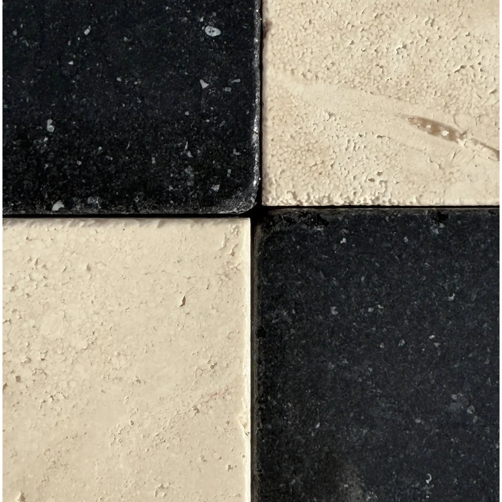 Black and white checkered tiles featuring Ivory Travertine 12X12 Cross-Cut Tumbled design