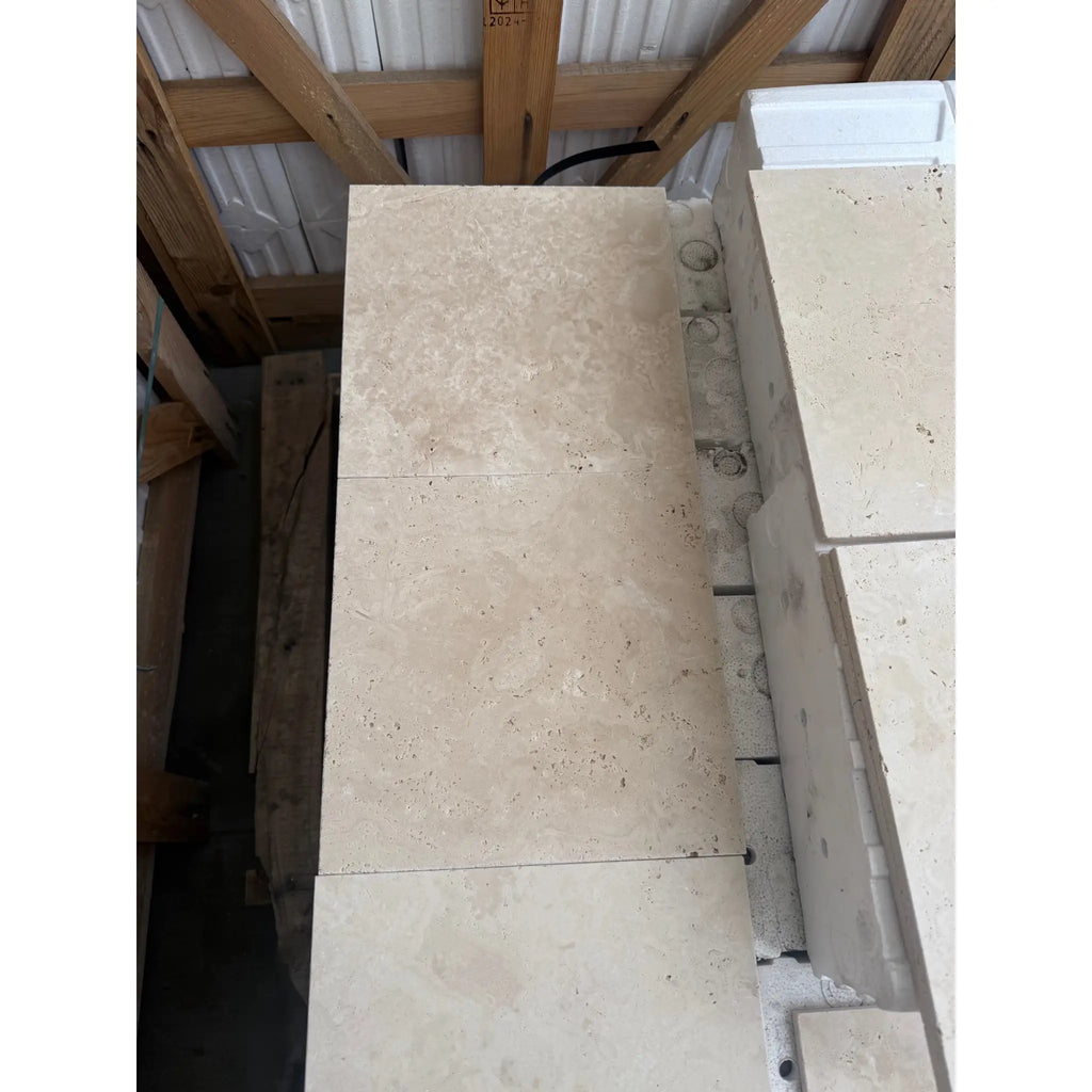 Stacked Ivory Light Travertine 12X12 Cross-Cut Tumbled tiles showcasing elegance