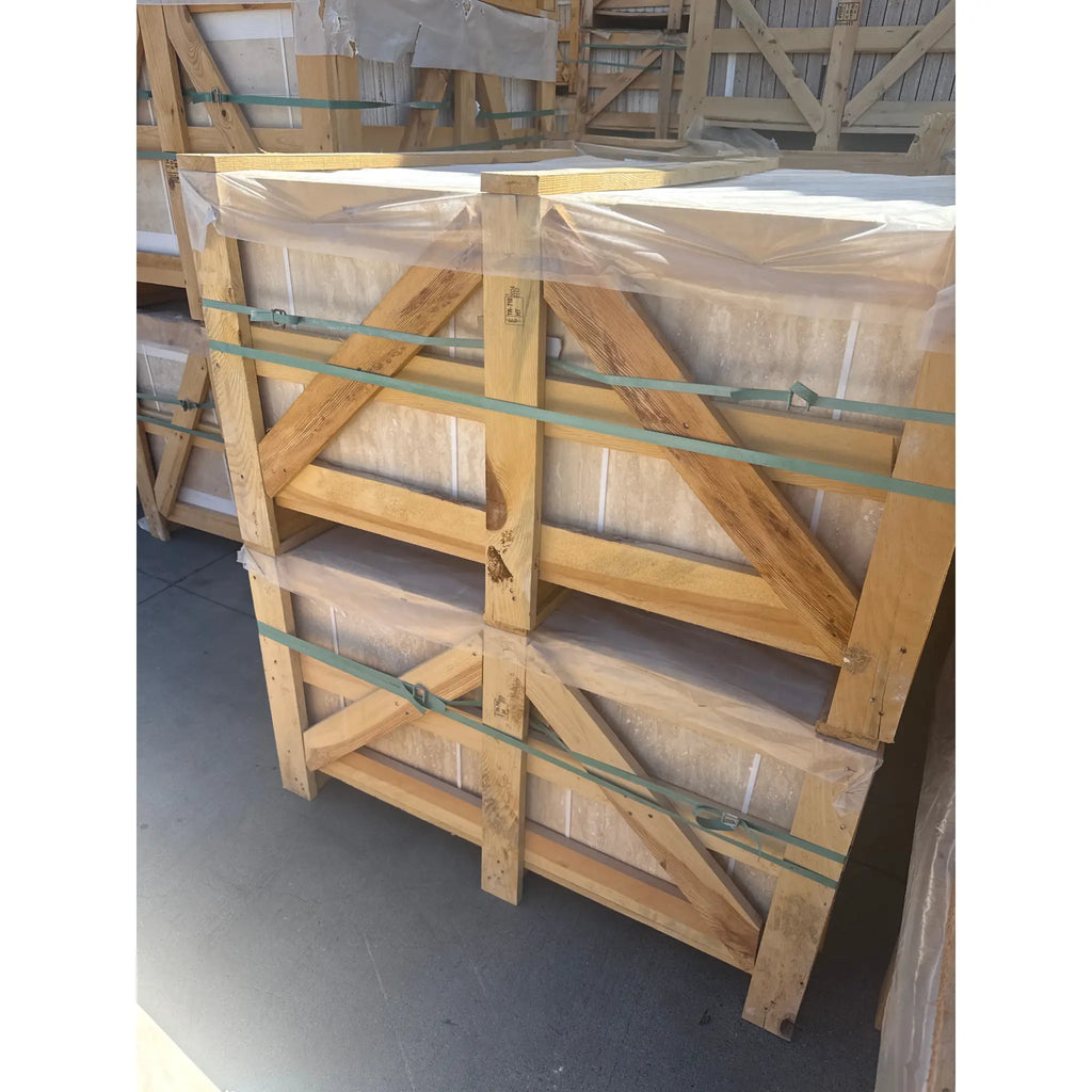 Wooden crates containing wrapped light Ivory Travertine 12x12 vein-cut tiles for transport